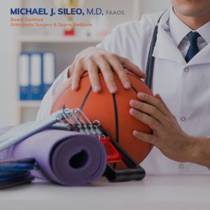 sports medicine doctor in selden dr. michael sileo A Sports Medicine Doctor in Selden, wearing a white coat, holds a basketball beside rolled yoga mats, a clipboard, and resistance bands, with medical credentials displayed in the background