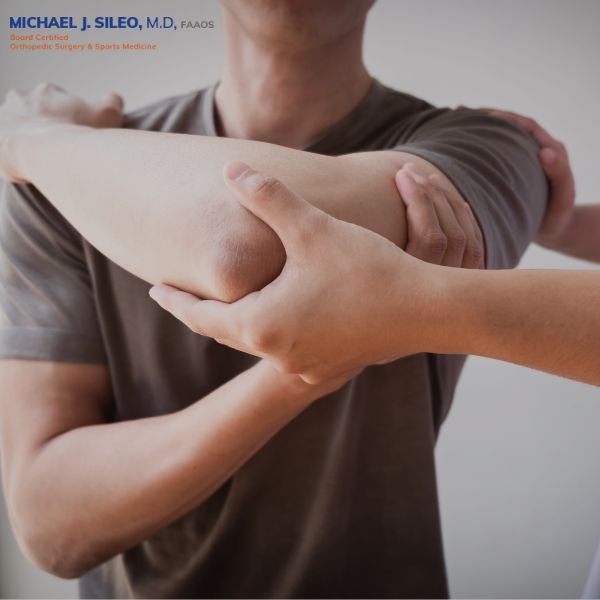 Man holding his shoulder in pain, showing rotator cuff exercises to avoid